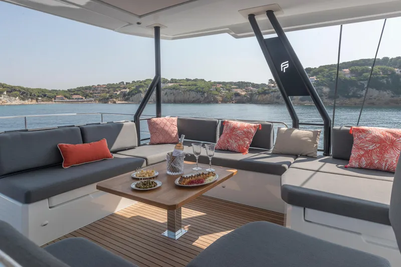 Slide: The Image of 2024 Fountaine Pajot Samana 59 yacht with luxurious outdoor seating and scenic ocean view. - 25