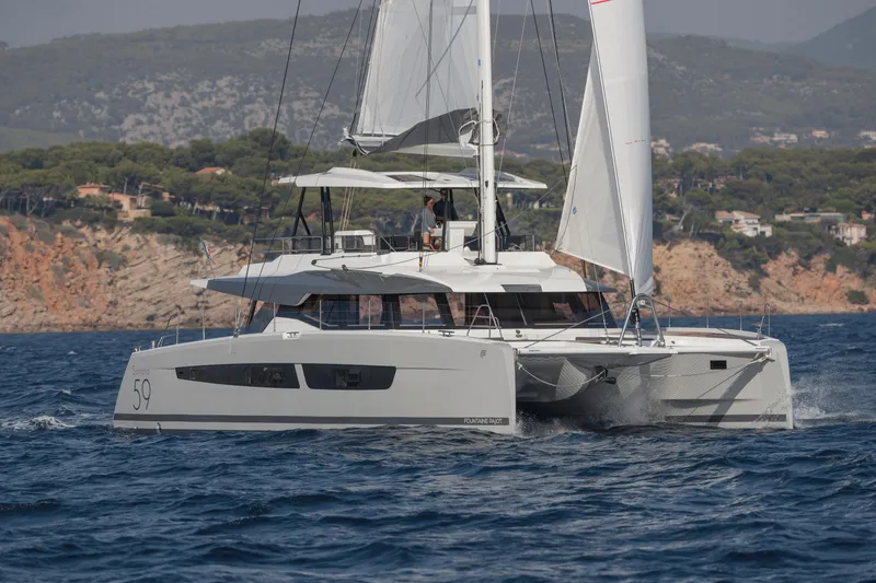 Slide: The Image of 2024 Fountaine Pajot Samana 59 sailing catamaran on open water. - 0