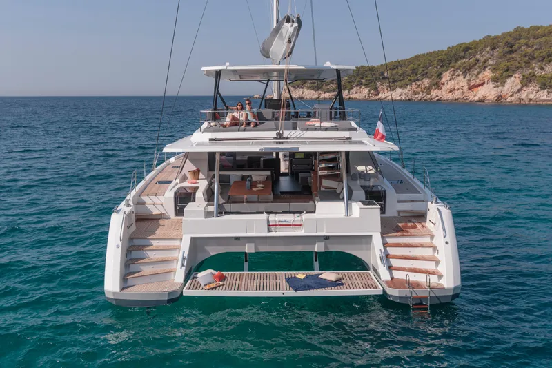 Slide: The Image of 2024 Fountaine Pajot Samana 59 catamaran anchored in clear blue waters. - 1