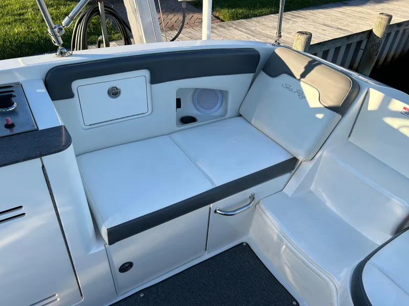 Slide: The Image of 2011 Sea Ray 300 Sundeck interior seating with storage and speaker. - 14