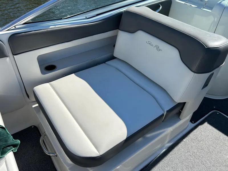 Slide: The Image of 2011 Sea Ray 300 Sundeck boat seat, featuring sleek gray and white upholstery. - 15