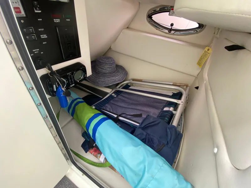 Slide: The Image of Interior storage of 2011 Sea Ray 300 Sundeck with beach gear and control panel. - 19