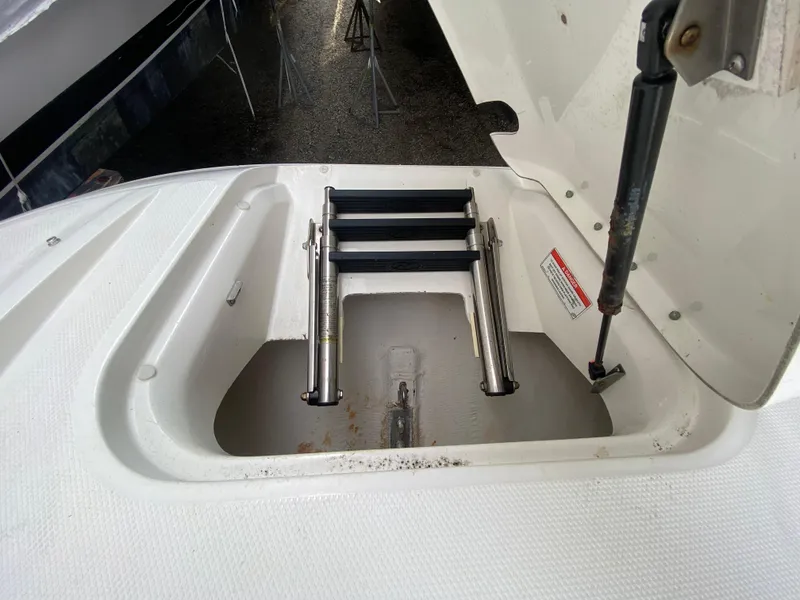 Slide: The Image of 2011 Sea Ray 300 Sundeck boat ladder compartment with hydraulic lift. - 20