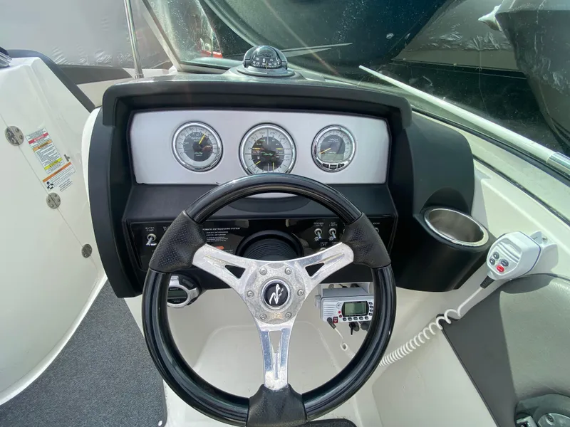 Slide: The Image of Dashboard of a 2011 Sea Ray 300 Sundeck boat with steering wheel and gauges. - 22
