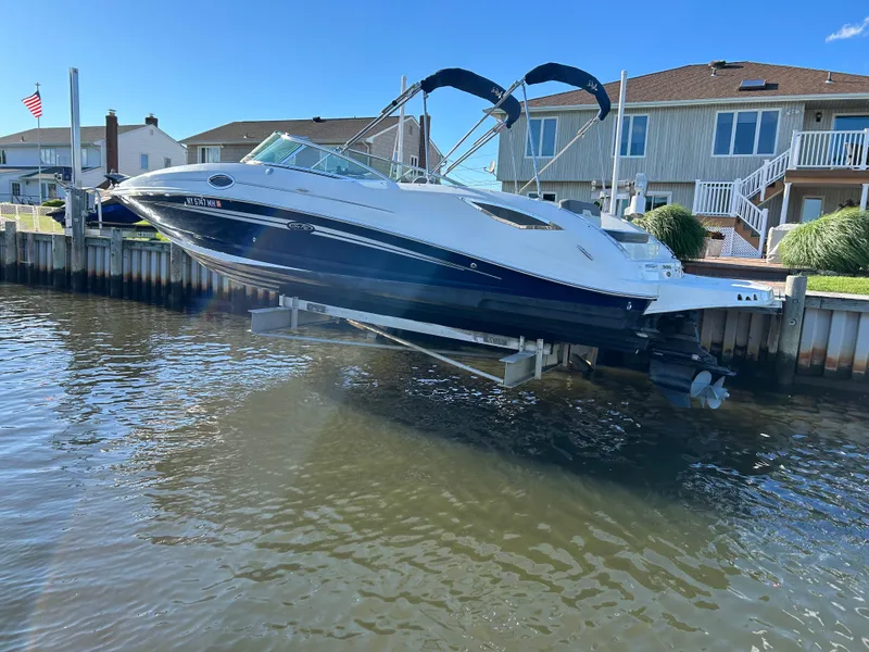 Slide: The Image of 2011 Sea Ray 300 Sundeck boat docked near waterfront homes. - 3