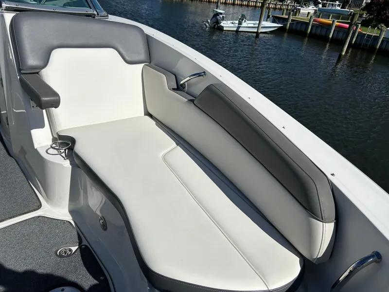 Slide: The Image of 2011 Sea Ray 300 Sundeck boat interior with cushioned seating by the water. - 34