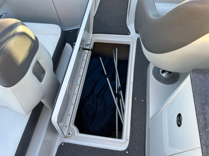 Slide: The Image of 2011 Sea Ray 300 Sundeck storage compartment with open lid, revealing interior space. - 36