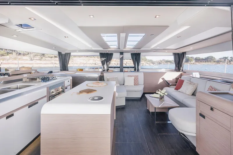 Slide: The Image of Luxurious interior of 2025 Fountaine Pajot Aura 51 catamaran with modern kitchen and spacious seating area. - 13