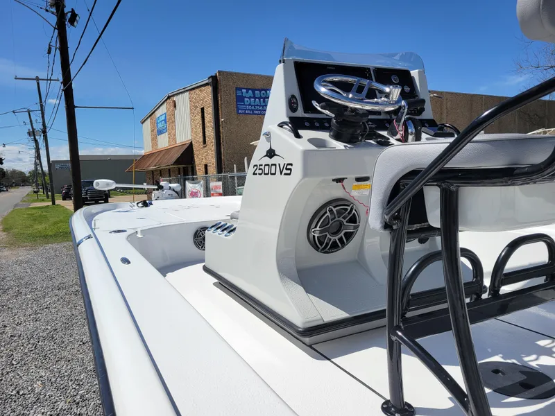 Slide: The Image of 2022 Turner Boatworks 2500 VS model displayed outdoors near a dealership. - 14