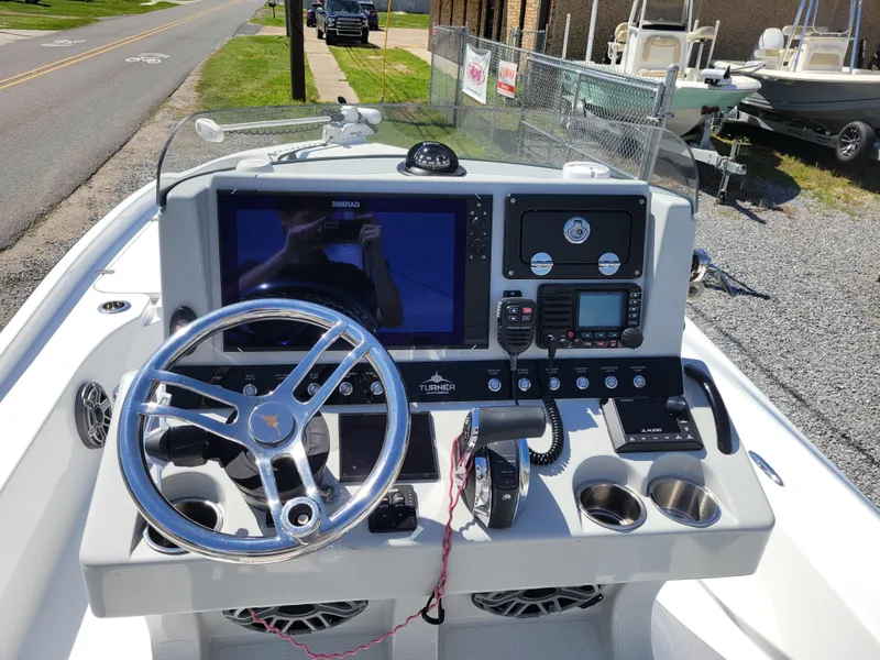 Slide: The Image of 2022 Turner Boatworks 2500 VS console with steering wheel and navigation system. - 15