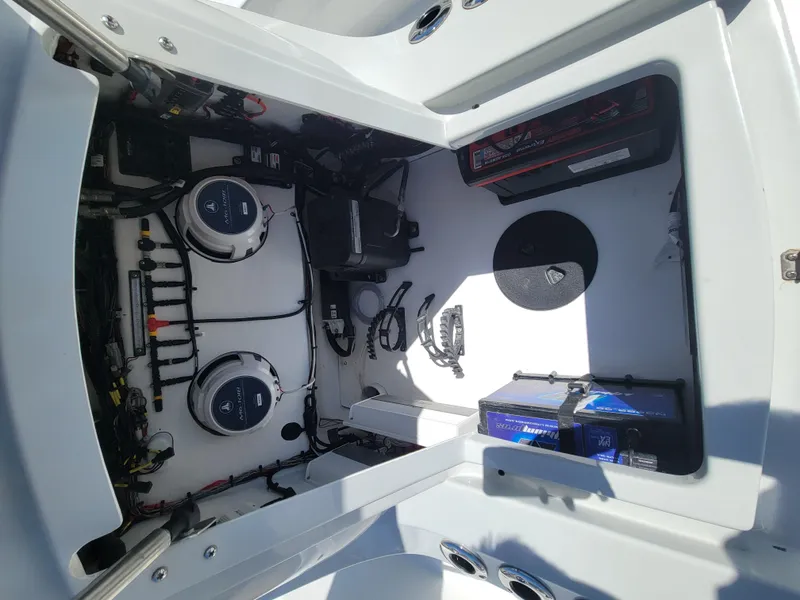 Slide: The Image of 2022 Turner Boatworks 2500 VS engine compartment with batteries and wiring. - 23