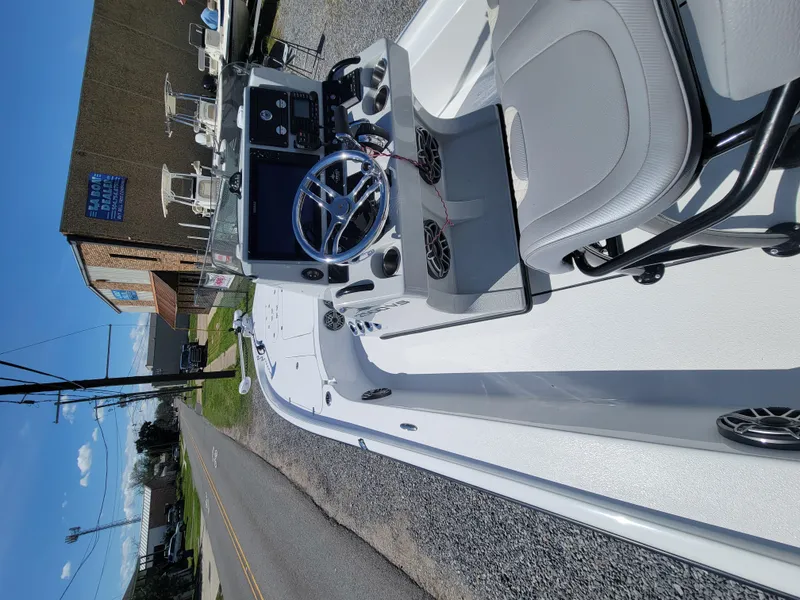 Slide: The Image of 2022 Turner Boatworks 2500 VS, white interior, parked on gravel near a building. - 27