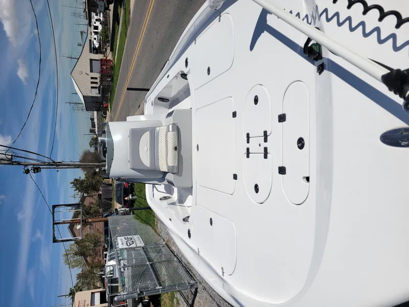 Slide: The Image of 2022 Turner Boatworks 2500 VS, white deck, parked on a street. - 9