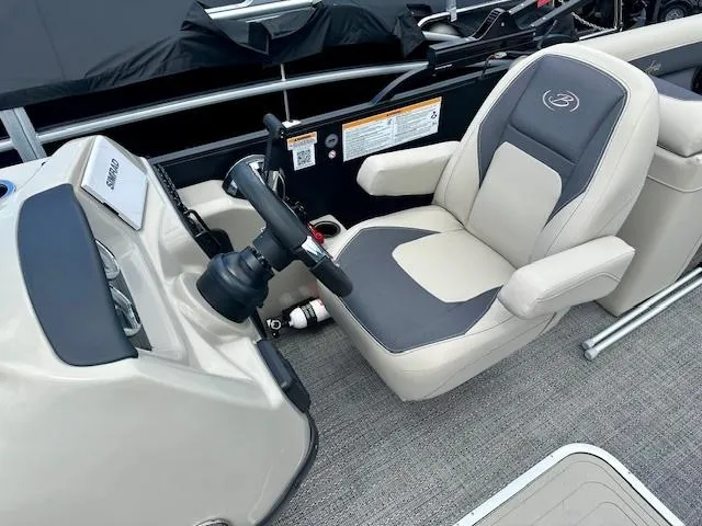 Slide: The Image of Captain's chair and helm of 2024 Barletta Aria 24QC pontoon boat. - 5