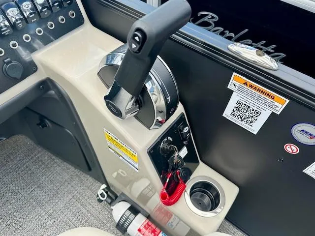 Slide: The Image of Control panel of 2024 Barletta Aria 24QC boat with throttle and safety features. - 9