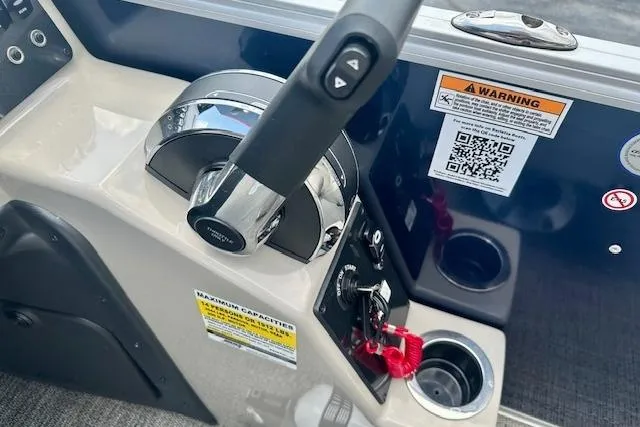 Slide: The Image of 2024 Barletta Aria 24UC boat control panel with throttle and warning labels. - 10