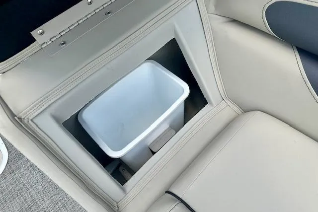 Slide: The Image of 2024 Barletta Aria 24UC boat interior with built-in storage compartment. - 13