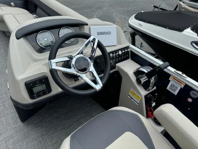 Slide: The Image of 2024 Barletta Aria 24UC boat dashboard with steering wheel and control panel. - 3