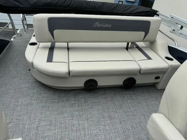 Slide: The Image of 2024 Barletta Aria 24UC boat interior with cushioned seating and cup holders. - 5