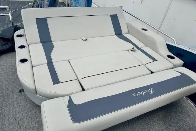 Slide: The Image of 2024 Barletta Aria 24UC boat seating with cup holders, featuring sleek gray and blue design. - 9