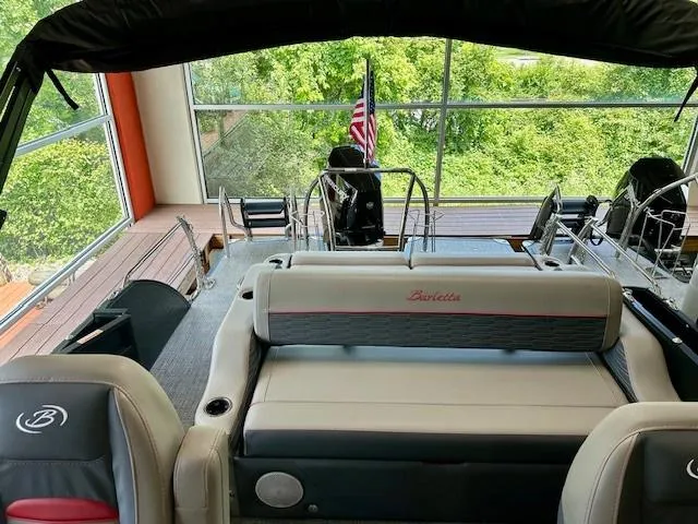 Slide: The Image of 2024 Barletta CORSA 25UC pontoon boat interior with luxurious seating and modern design. - 11
