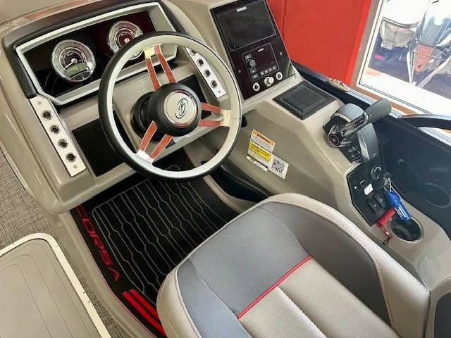 Slide: The Image of 2024 Barletta CORSA 25UC boat cockpit with steering wheel and control panel. - 7