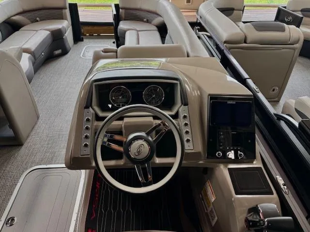 Slide: The Image of 2024 Barletta CORSA 25UC boat interior with modern dashboard and spacious seating. - 8