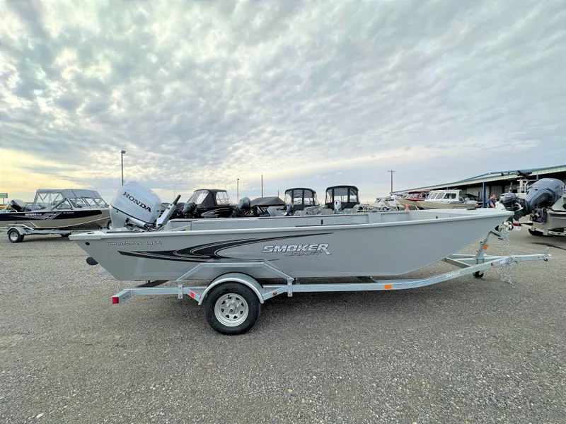 The Image of 2023 Smoker Craft Sportsman Pro 1866 boat on a trailer in a marina. - 0
