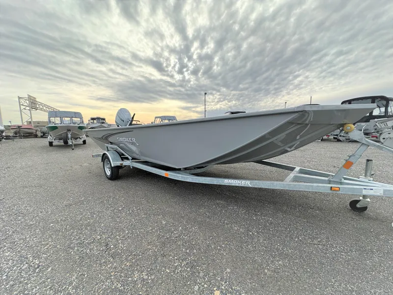 Slide: The Image of 2023 Smoker Craft Sportsman Pro 1866 boat on a trailer under a cloudy sky. - 1