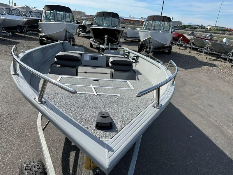 Slide: The Image of 2024 Smoker Craft Pro Lodge 160 fishing boat on display in a lot. - 2