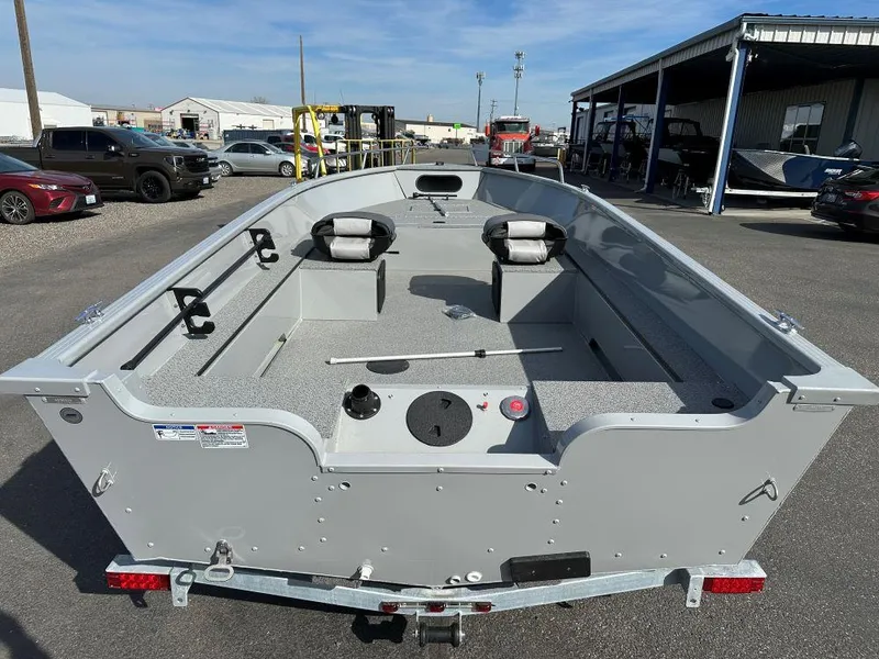 Slide: The Image of 2024 Smoker Craft Pro Lodge 160 fishing boat, rear view, parked outdoors. - 3