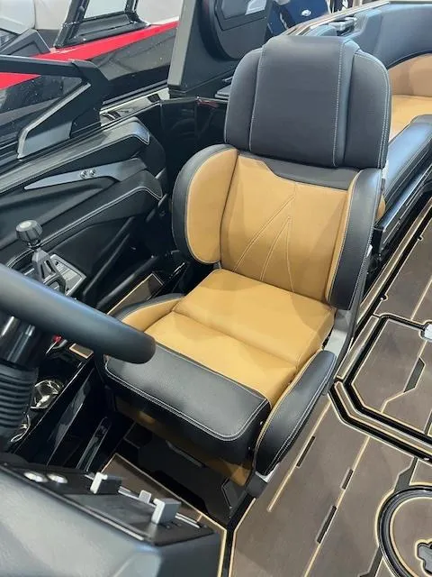 Slide: The Image of 2024 Supra SL boat interior with luxurious tan and black captain's seat. - 11