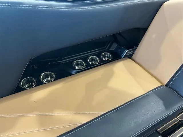 Slide: The Image of 2024 Supra SL interior with beige and black leather seats and multiple cup holders. - 16