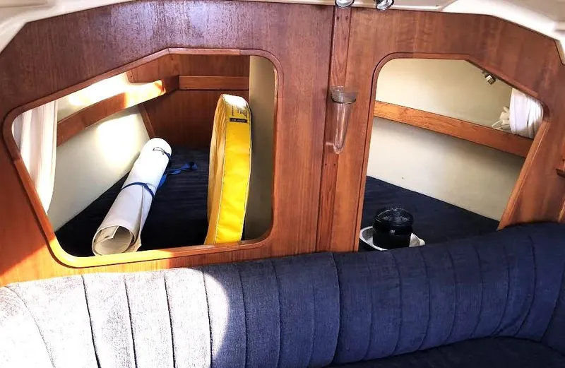 Slide: The Image of Interior of 1990 Hunter Vision 32 sailboat with wooden cabinetry and blue upholstery. - 11