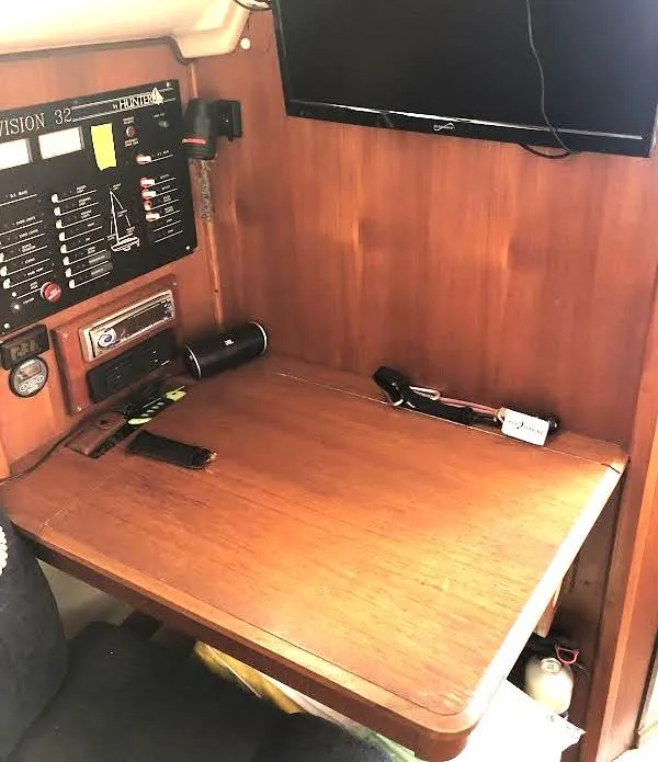 Slide: The Image of 1990 Hunter Vision 32 yacht interior with navigation station and control panel. - 15