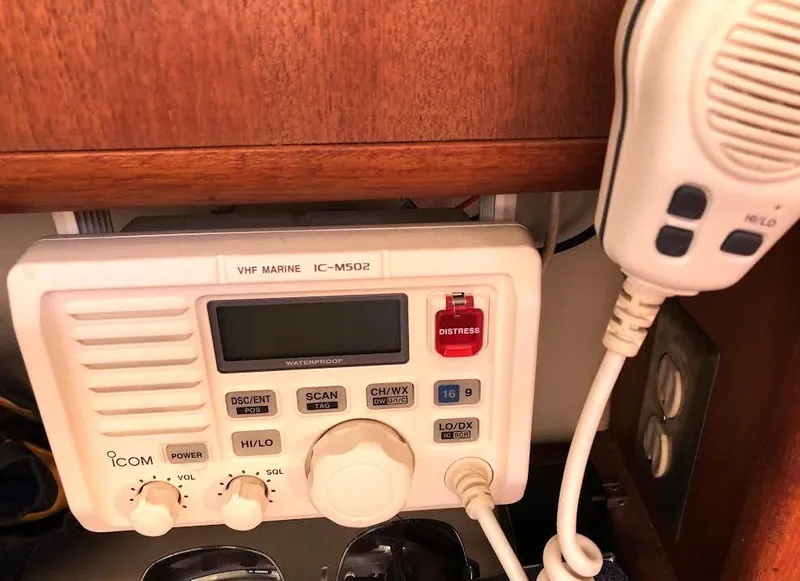 Slide: The Image of VHF marine radio on 1990 Hunter Vision 32 sailboat, featuring Icom IC-M502 model. - 16