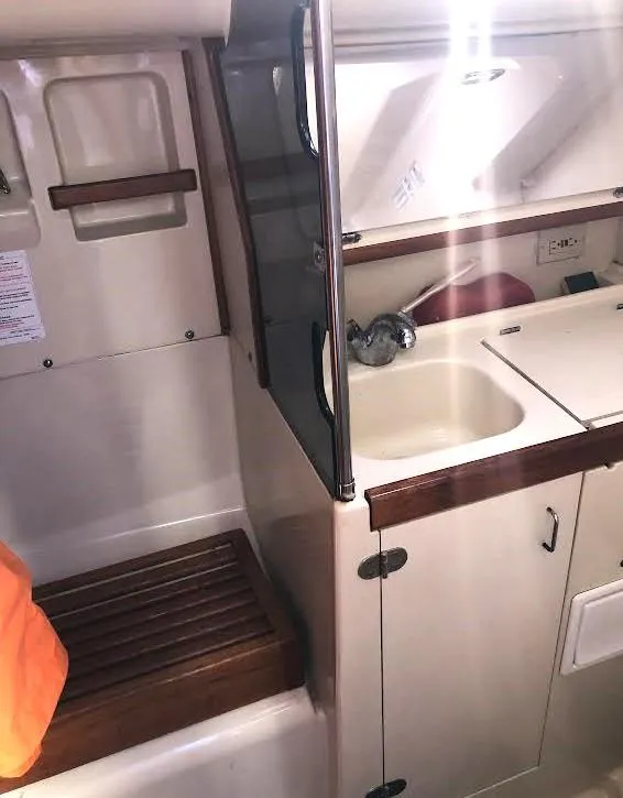 Slide: The Image of 1990 Hunter Vision 32 yacht interior with sink and wooden accents. - 17