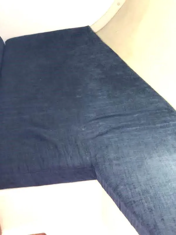 Slide: The Image of Blue fabric upholstery on a 1990 Hunter Vision 32 boat interior. - 19