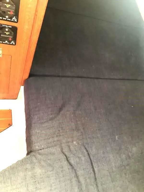 Slide: The Image of Interior of 1990 Hunter Vision 32 sailboat with dark fabric and wooden paneling. - 20