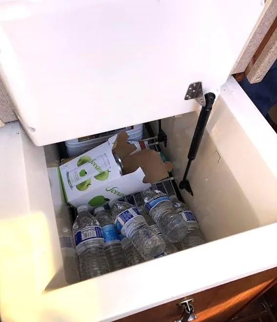 Slide: The Image of Open cooler on Hunter Vision 32 yacht with water bottles and beverage box. - 23