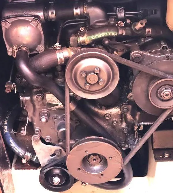 Slide: The Image of Engine of a 1990 Hunter Vision 32 sailboat, showcasing belts and components. - 24