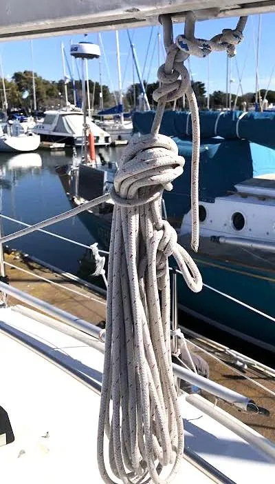 Slide: The Image of Coiled rope on 1990 Hunter Vision 32 sailboat, docked at marina with other boats. - 28