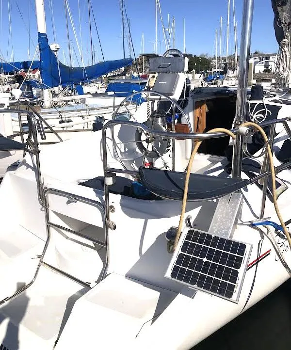 Slide: The Image of 1990 Hunter Vision 32 sailboat with solar panel, docked in a marina. - 3