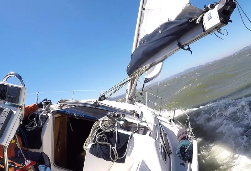 Slide: The Image of Sailing on a 1990 Hunter Vision 32 yacht in choppy waters under clear blue skies. - 9