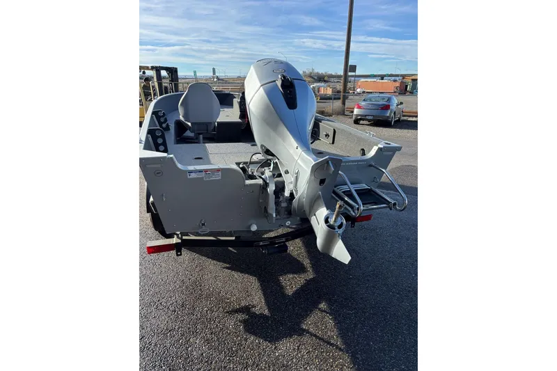 Slide: The Image of 2024 Starweld 16 Fusion SC Pro boat with outboard motor, parked on asphalt. - 10