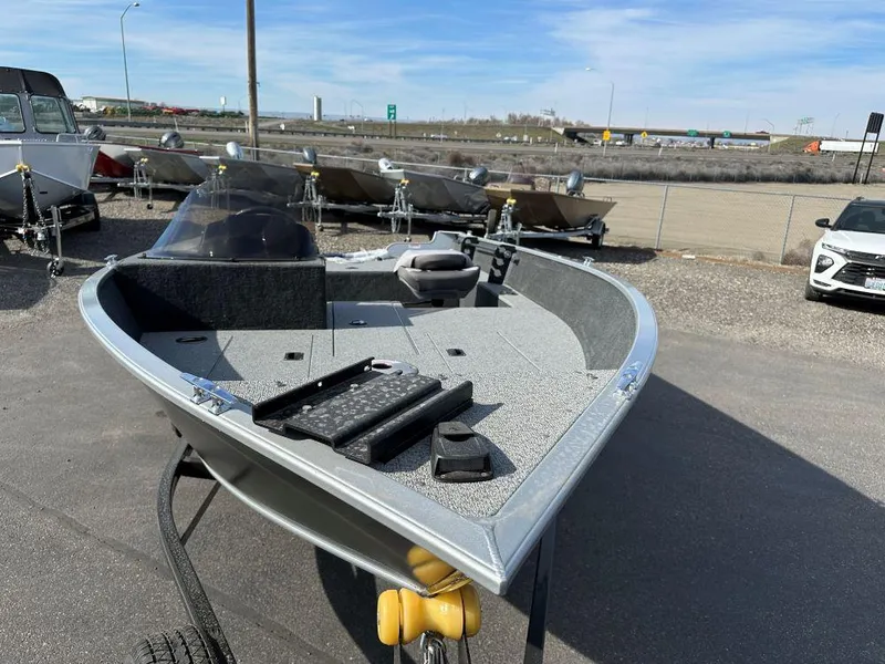 Slide: The Image of 2024 Starweld 16 Fusion SC Pro boat on a trailer in a parking lot. - 2