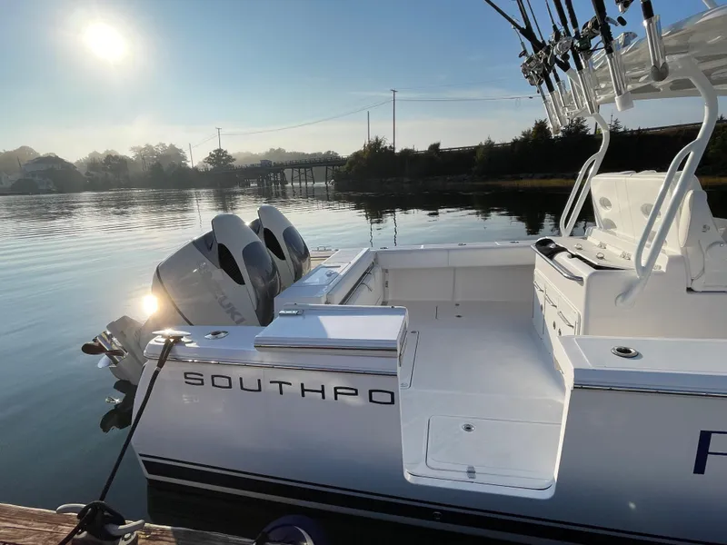 Slide: The Image of 2018 Southport 33 FE boat docked on a calm lake at sunrise. - 11