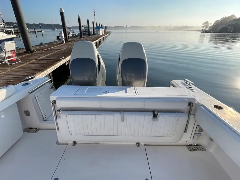 Slide: The Image of 2018 Southport 33 FE boat docked at a marina with twin engines. - 13