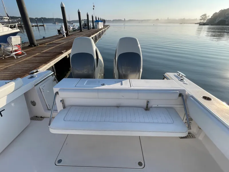 Slide: The Image of 2018 Southport 33 FE boat with twin engines docked at a marina. - 14