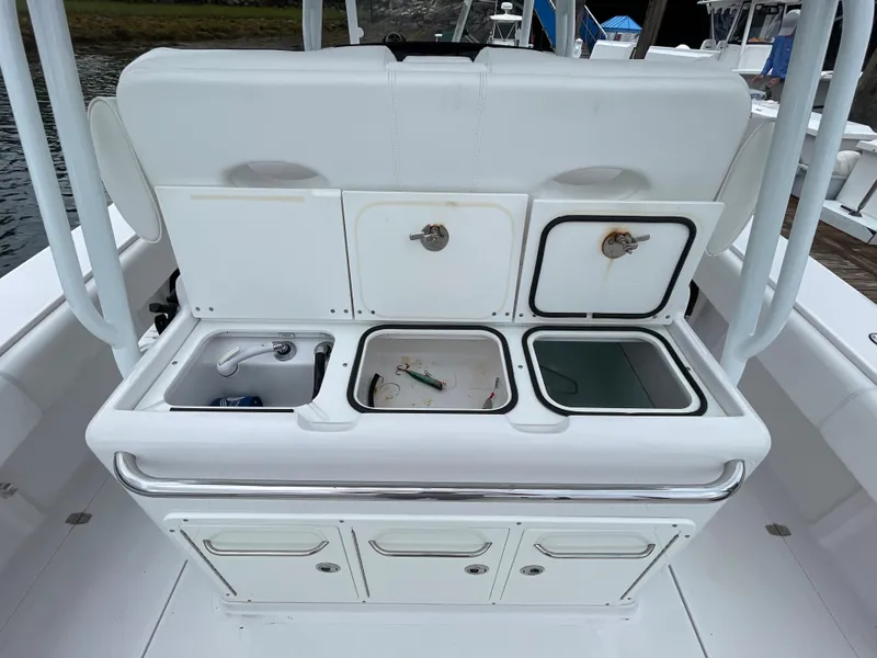 Slide: The Image of 2018 Southport 33 FE boat with open storage compartments and sink. - 18